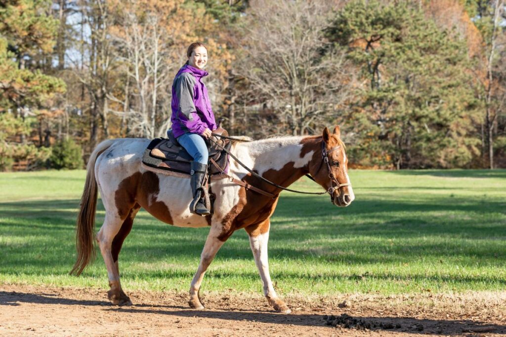 Woman riding a horse at Southern Cross Guest Ranch.