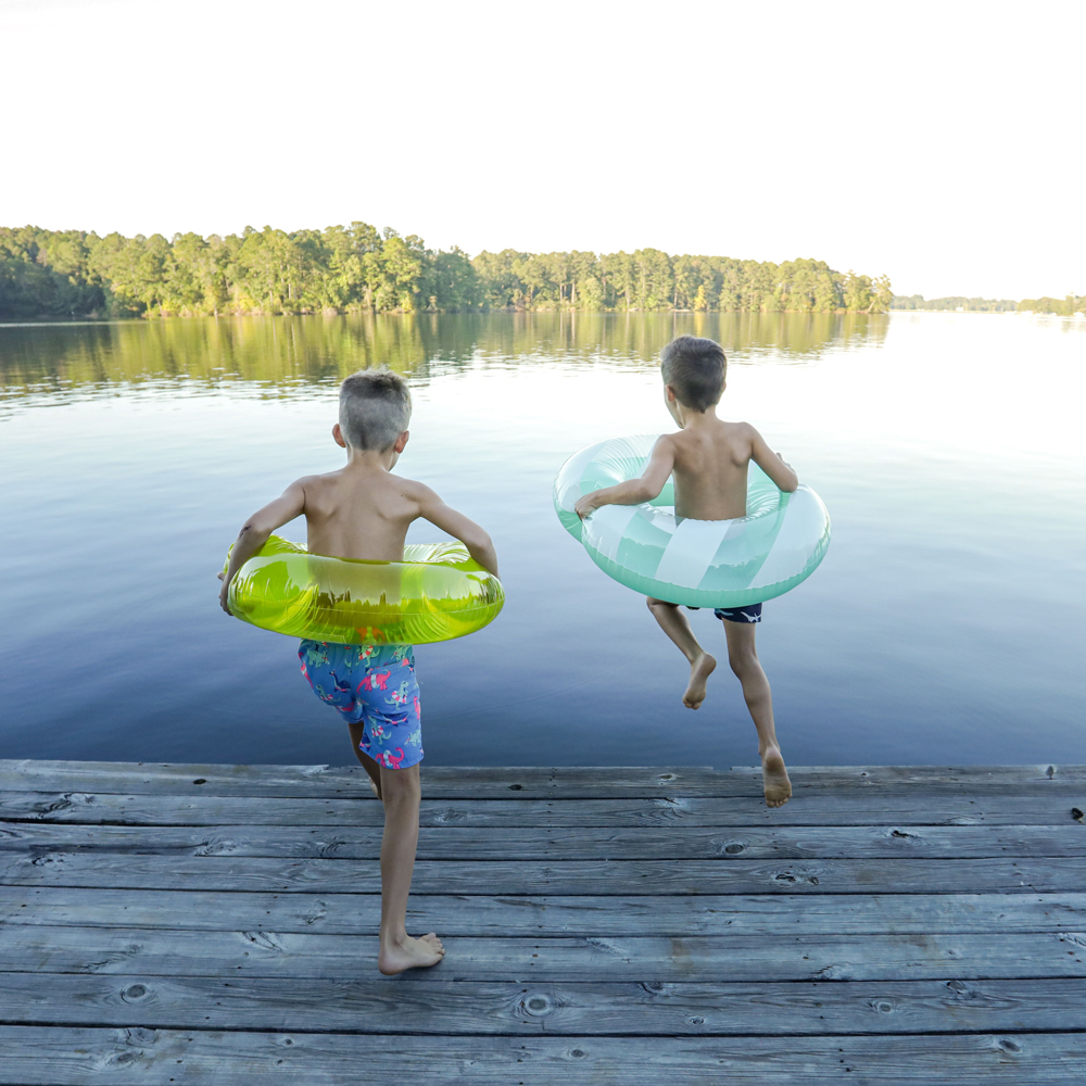 Kids in tubes jumping into water