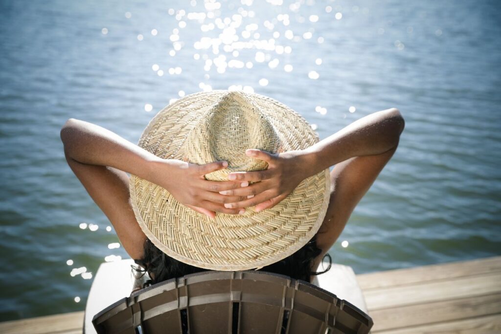 Person relaxing in a chair along Lake Sinclair.
